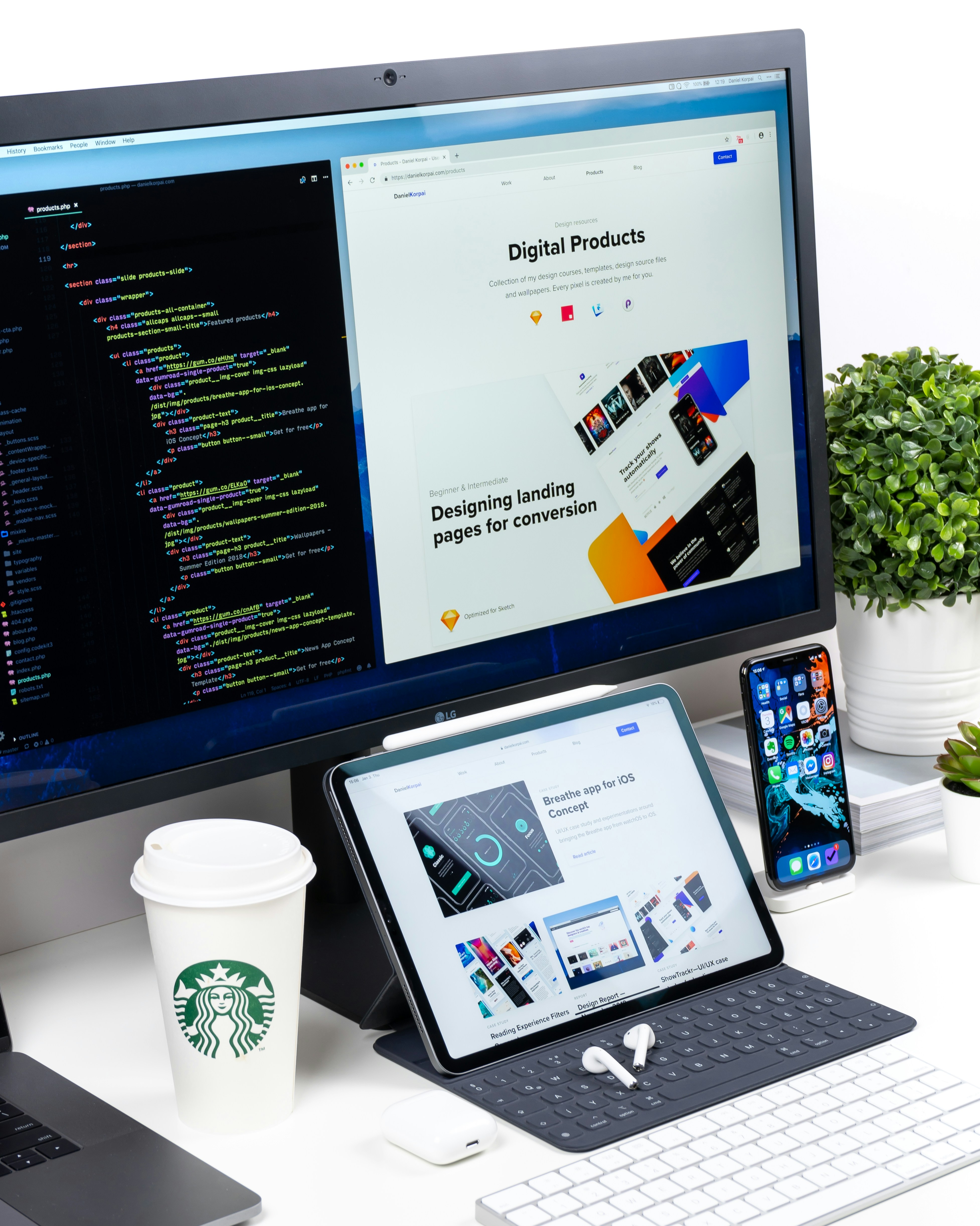 Web designer's workspace with code on screen and multi-device previews